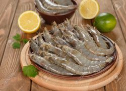 Raw shrimp on brown plate